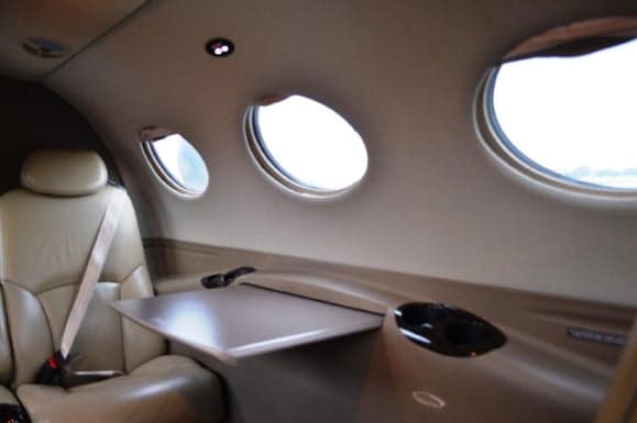 Interior of the Citation Mustang showing the seating area and oval windows.
