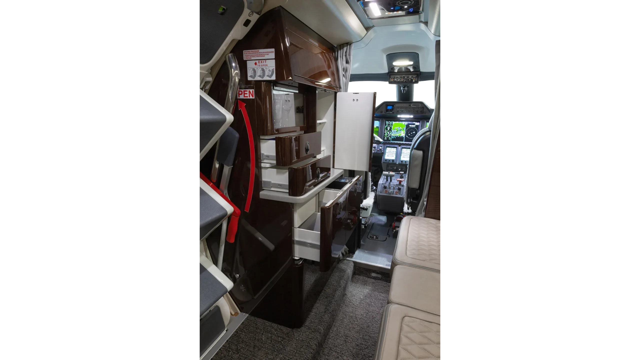 View of the aircraft interior showing the galley and cockpit.