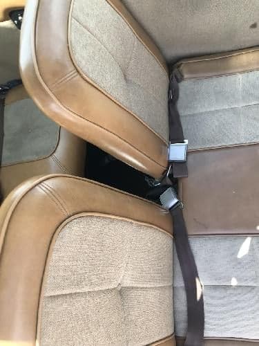 Close-up of the tan and brown fabric seats inside the aircraft cabin.