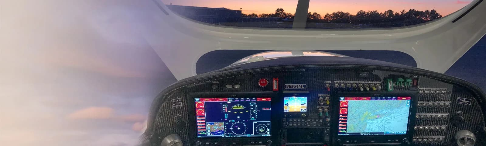 Modern aircraft cockpit with digital displays and a view of the runway.