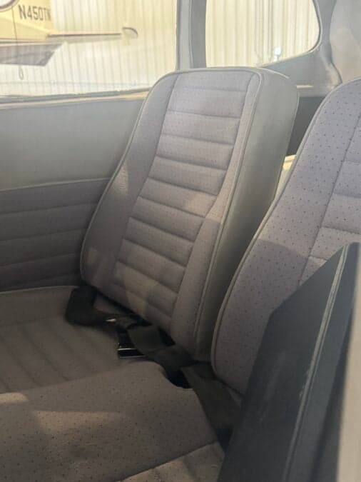 Close-up of the gray fabric seats in the aircraft cabin.