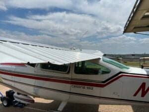 Partial side view of a Cessna 182 Skylane, registration N71699, parked on a paved surface.
