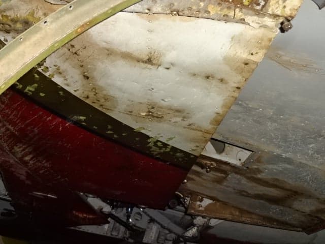 Close-up of the aircraft's internal structure with visible paint and rivets.