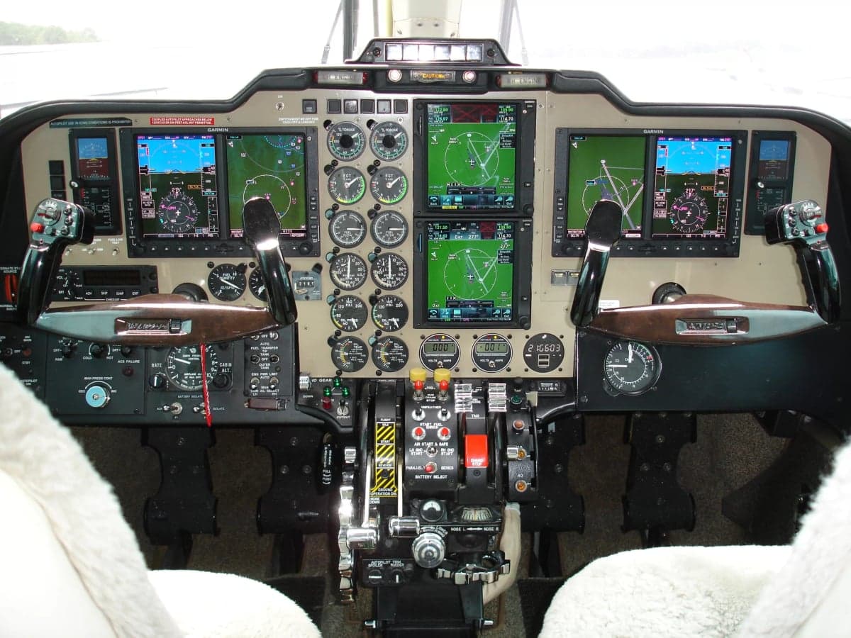 The cockpit features a full instrument panel with modern avionics.