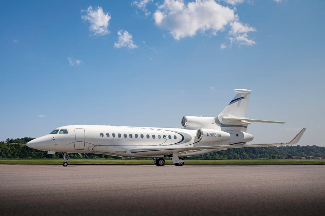 Side view of the white N988NW aircraft on the tarmac.