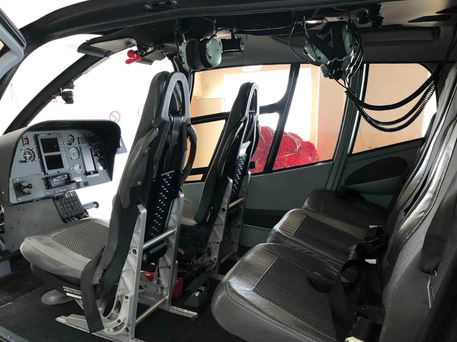 The interior of the helicopter has gray seats and black flooring.