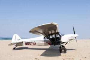 Side view of N864G aircraft on a beach.