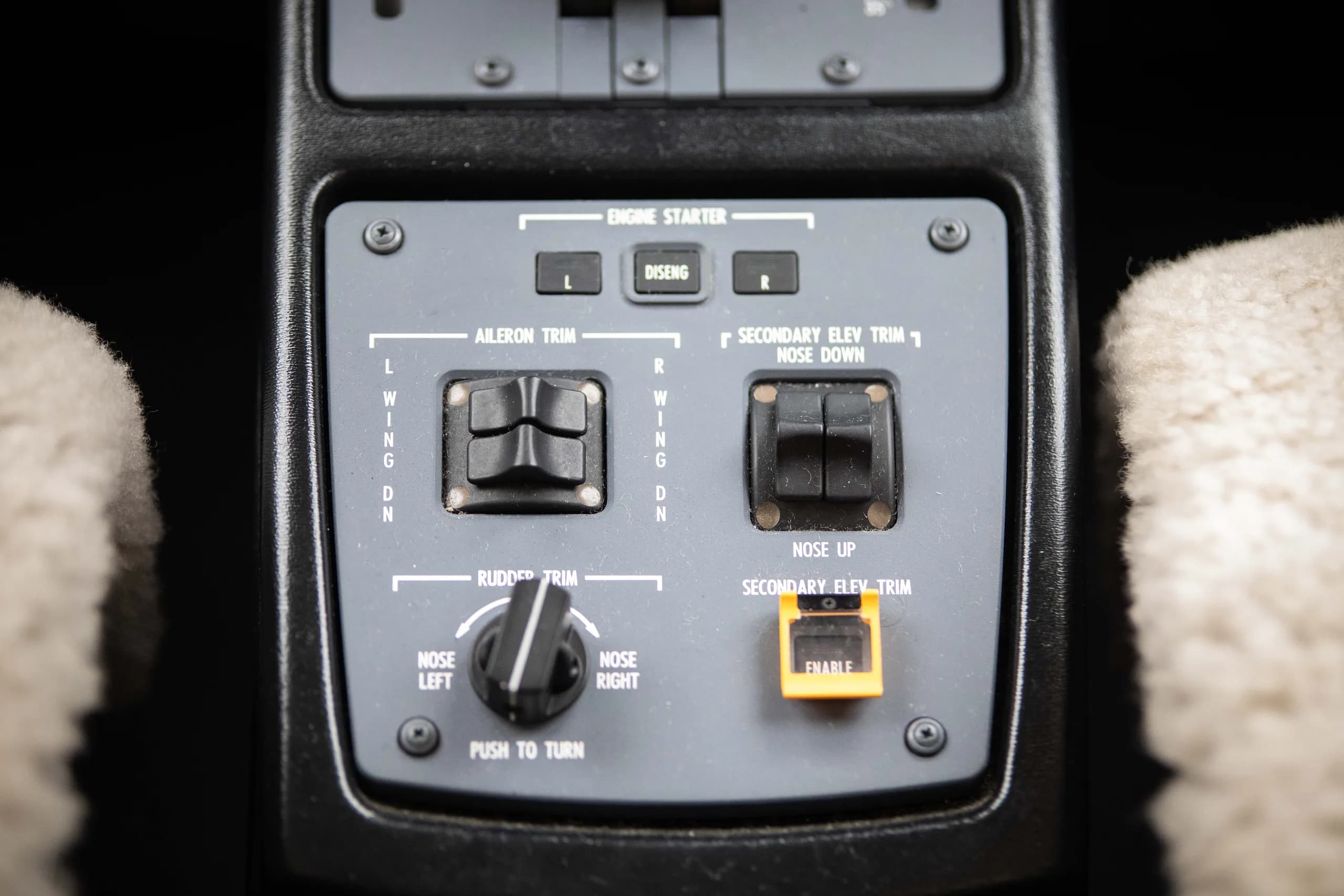 A close-up of an aircraft's trim and engine starter control panel.