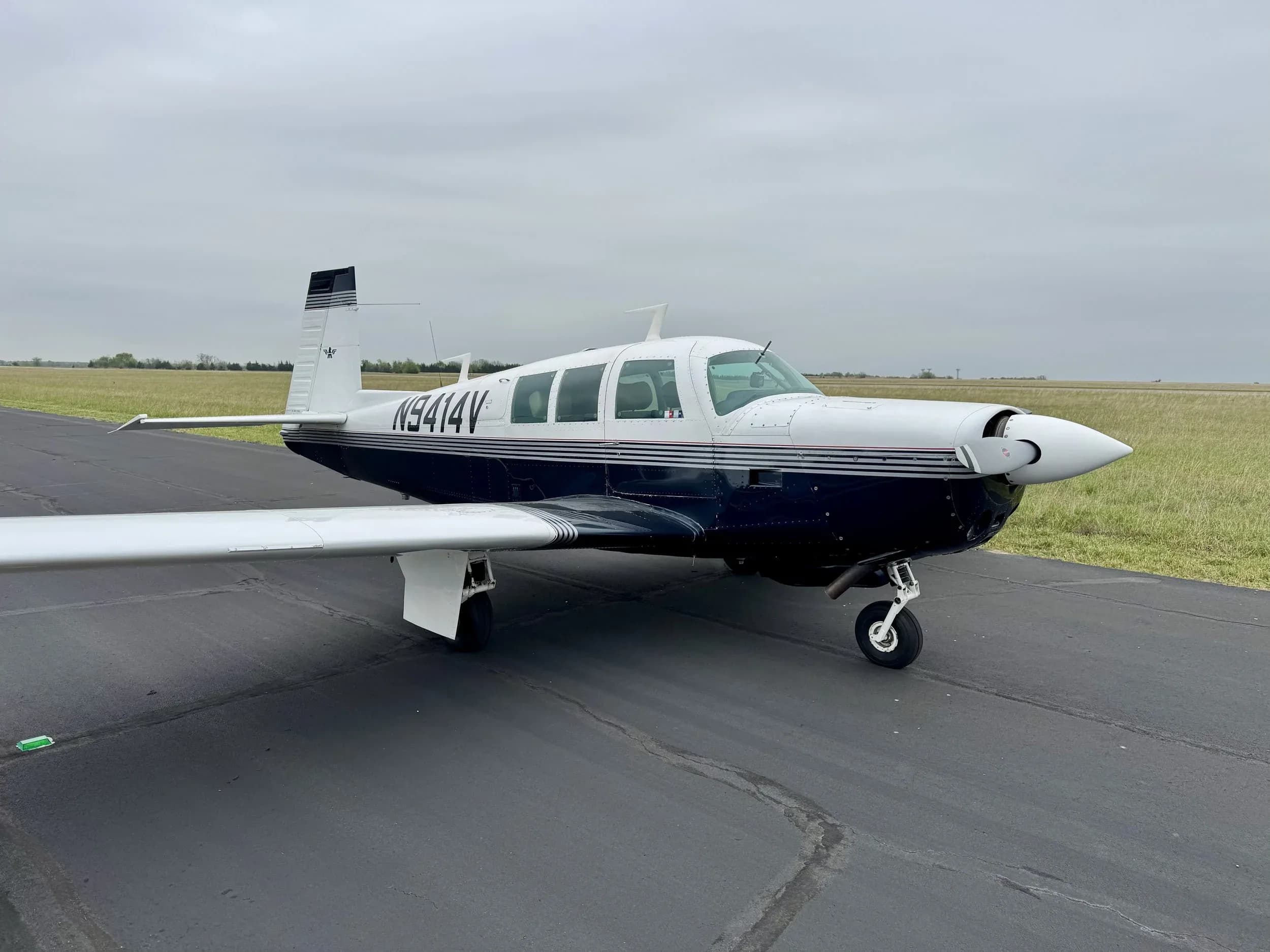 A Beechcraft Bonanza aircraft with registration N9414V is parked on the tarmac.