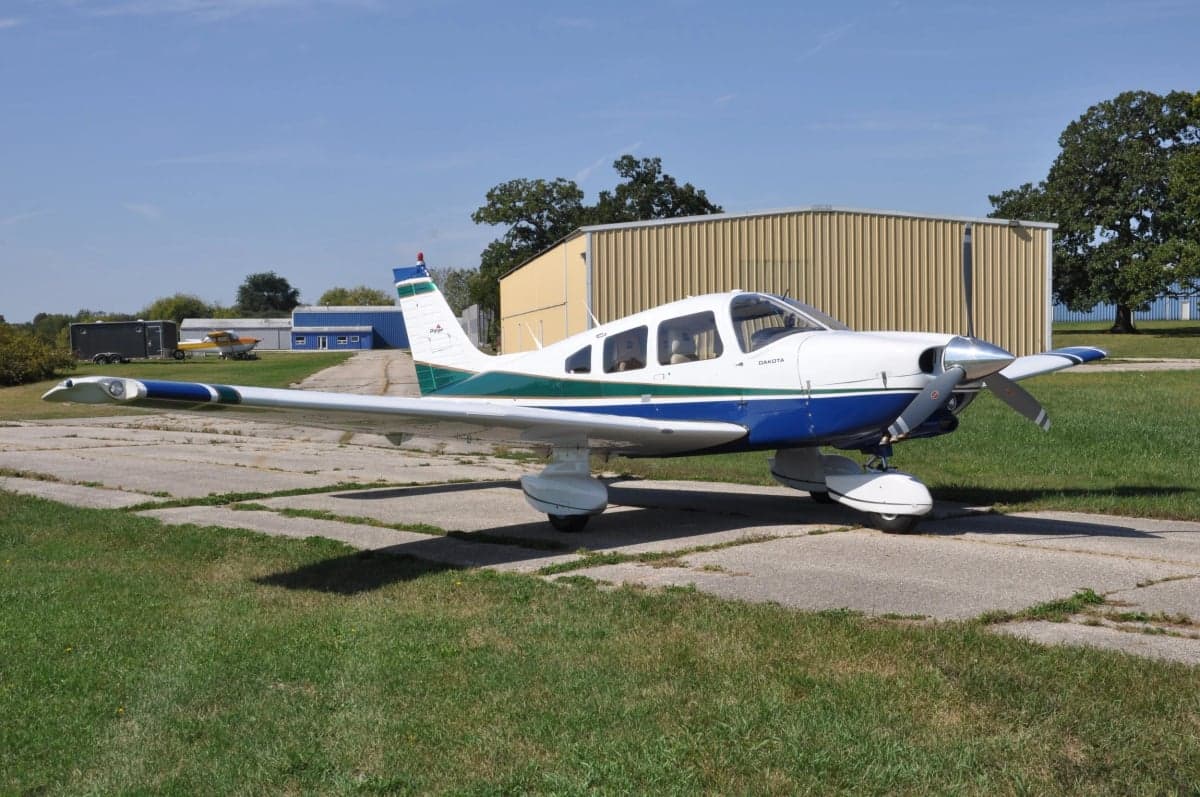 A Piper Dakota aircraft parked on a runway.