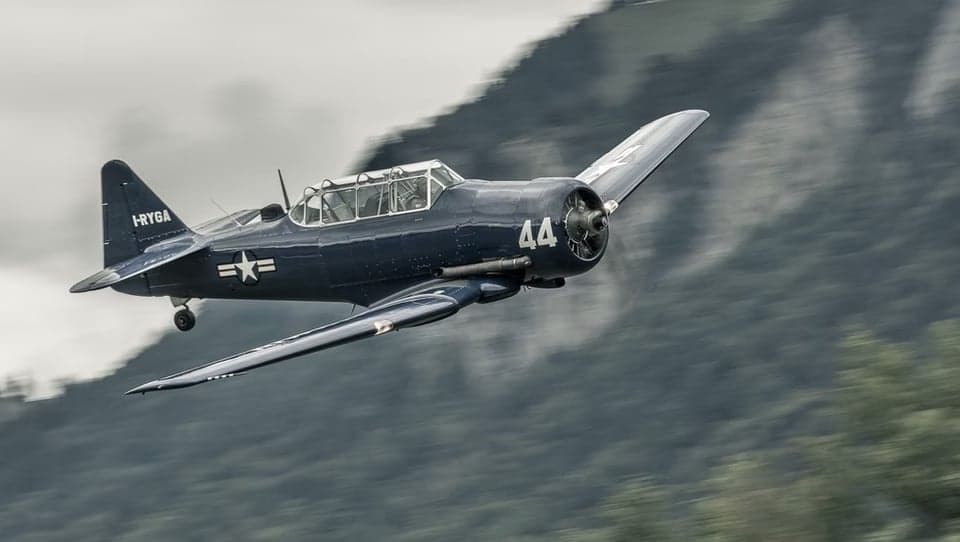 A blue North American T-6 Texan aircraft on the ground.