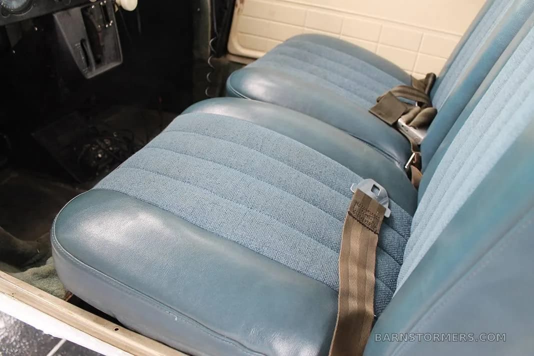 Close-up view of the blue fabric and vinyl seats in the aircraft cabin.