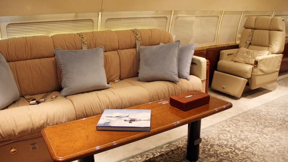 A comfortable sofa and table inside the aircraft cabin.