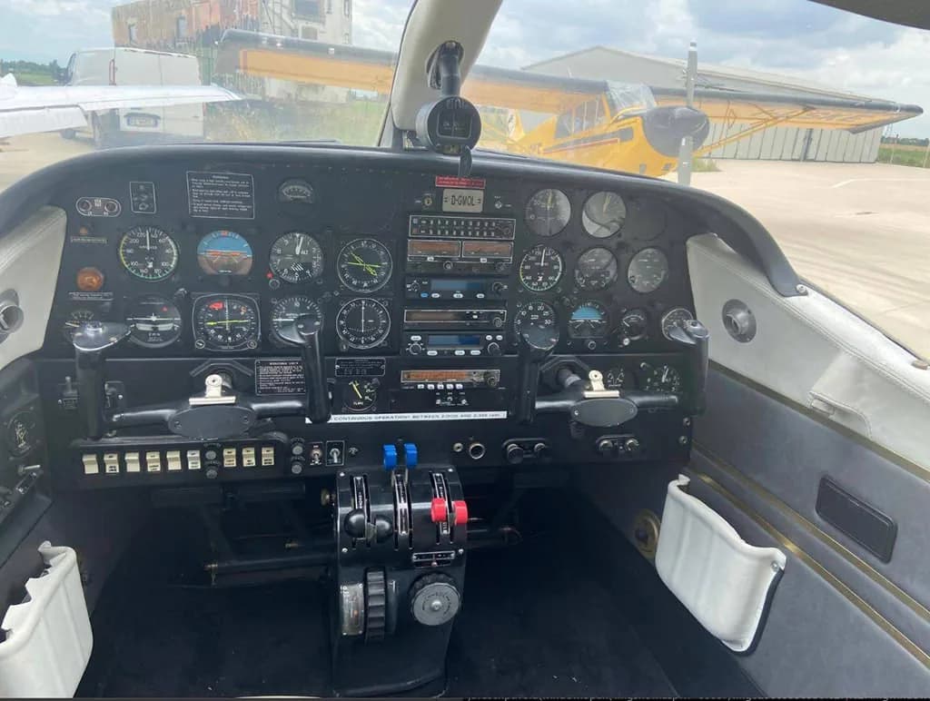 The detailed instrument panel and controls of the Partenavia P.68 cockpit, with another aircraft visible outside.