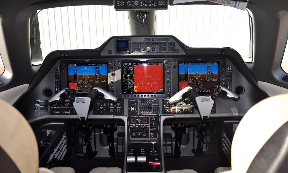 Interior view of the aircraft showing storage and seating.