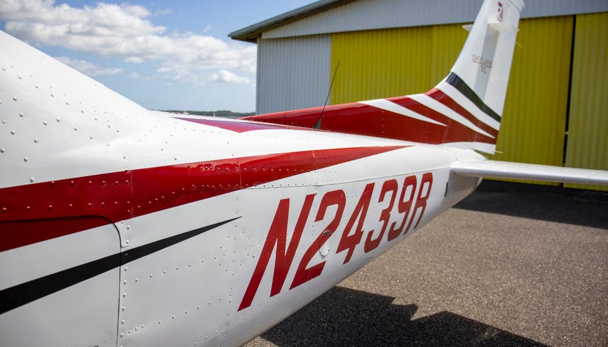 Close up of the tail of a Cessna Skylane TC, registration N2439R, with a red and white paint scheme.