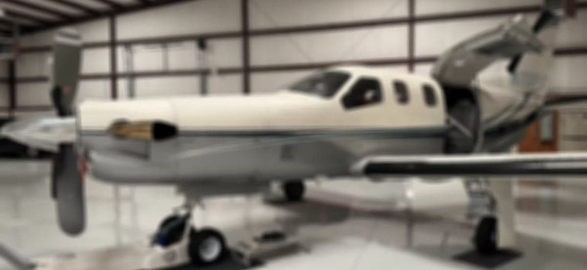 Aircraft with open door and steps, showing tail number N235SF.