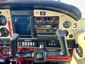 Close-up of the instrument panel and yoke in the cockpit of a Piper PA-28 Cherokee.