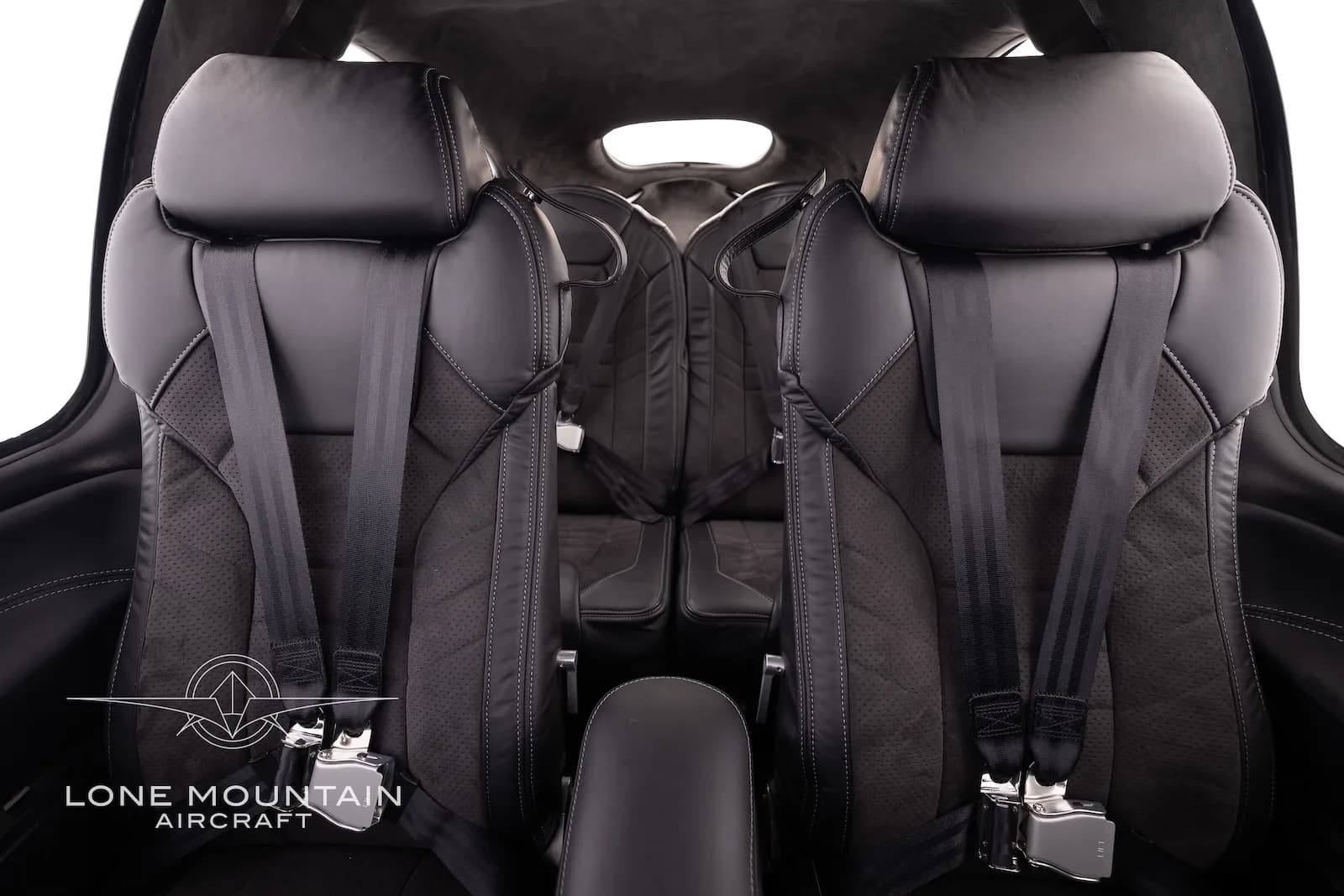 The black leather interior cabin seats of the Cirrus SR22 aircraft, showing two front seats with seatbelts.