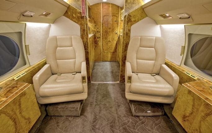 Aircraft cabin with table and seating.