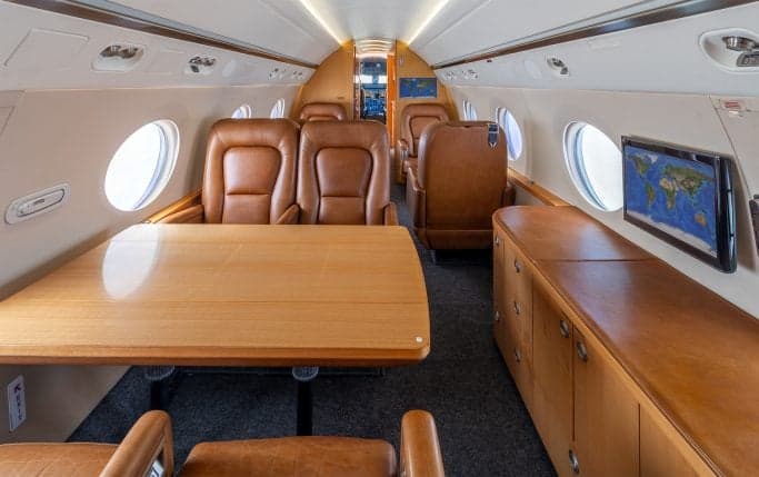 Aircraft cabin interior with couches.