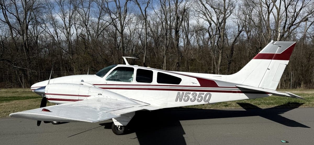 N535Q Beechcraft on the tarmac with a white and maroon paint scheme.