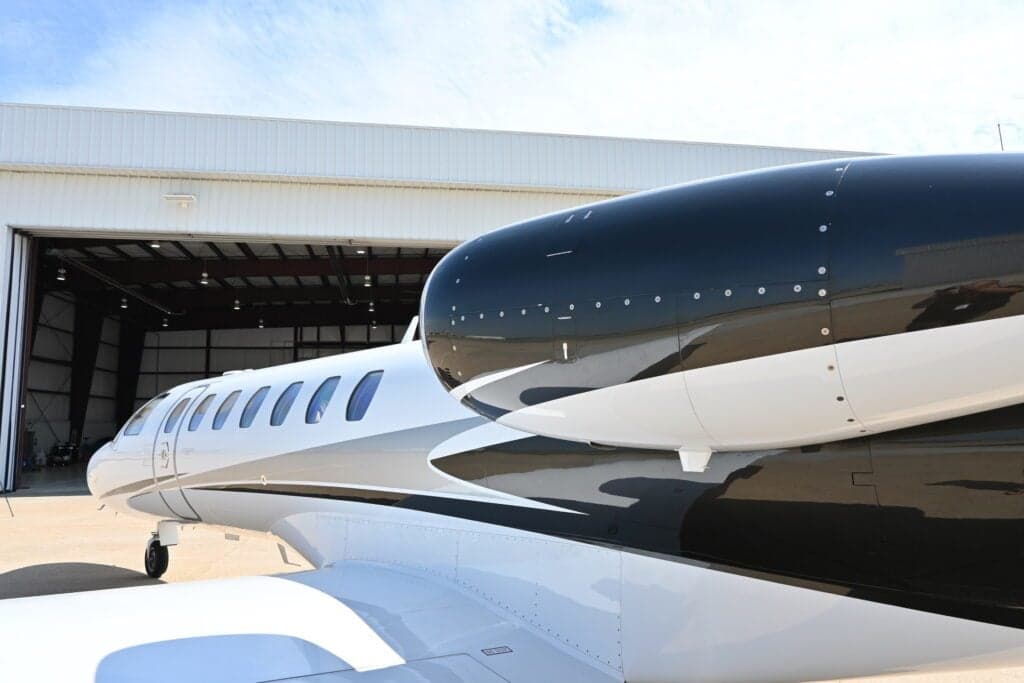 Close up of the engine and fuselage of a Cessna Citation CJ3+.