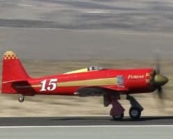 Side view of a red and gold Furias aircraft with the number 15 on the side.