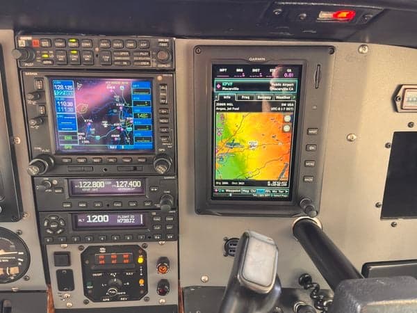 Avionics stack and instrument panel of N738JZ, showing Garmin displays.
