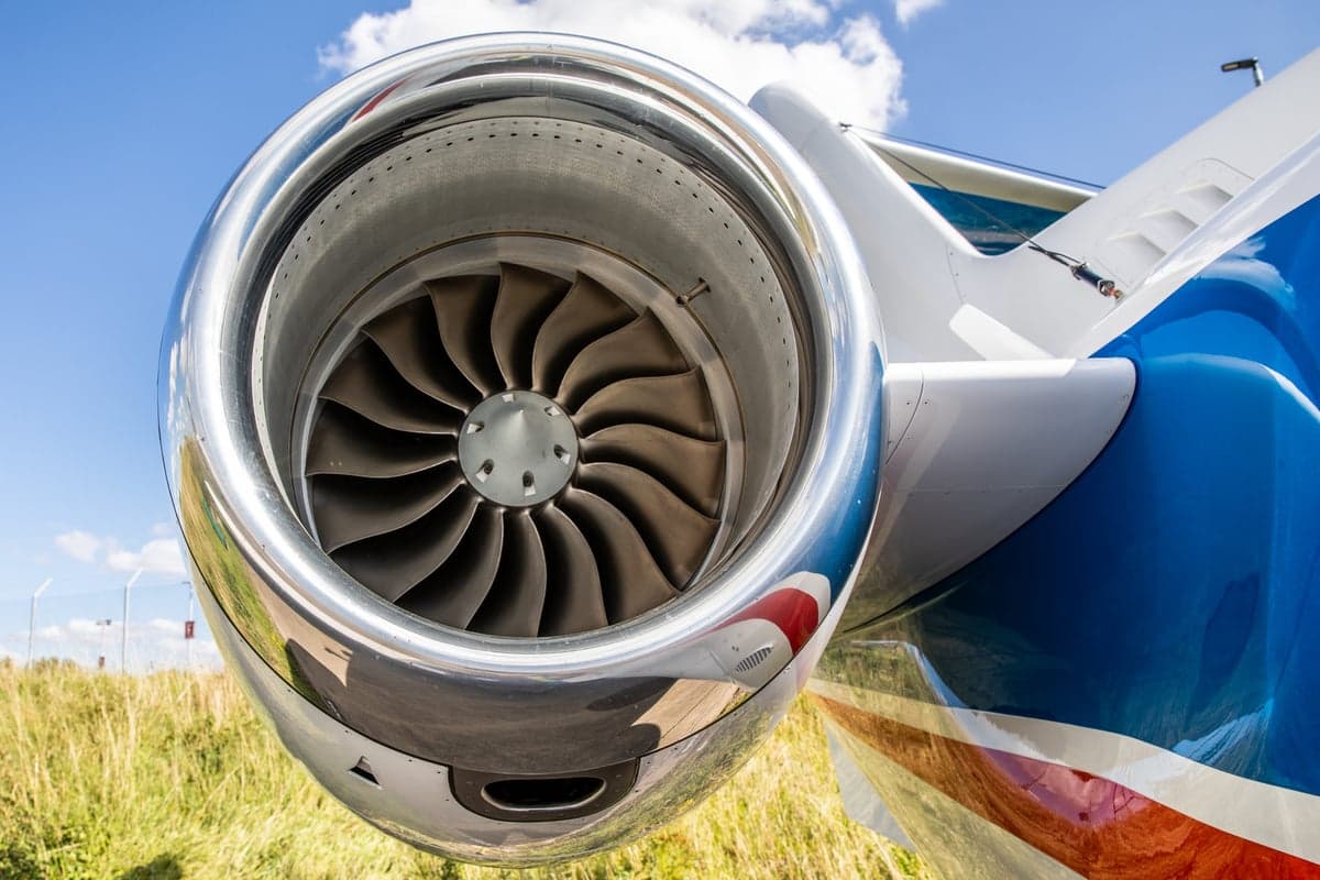 Close-up of the aircraft engine with a red, white, and blue paint scheme.
