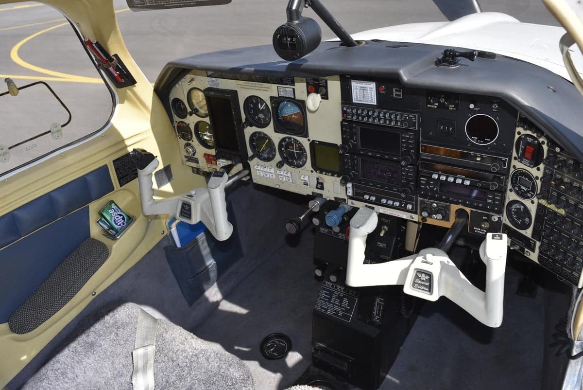 Wide view of the aircraft's cockpit, showing the instrument panel, control yokes, and interior.