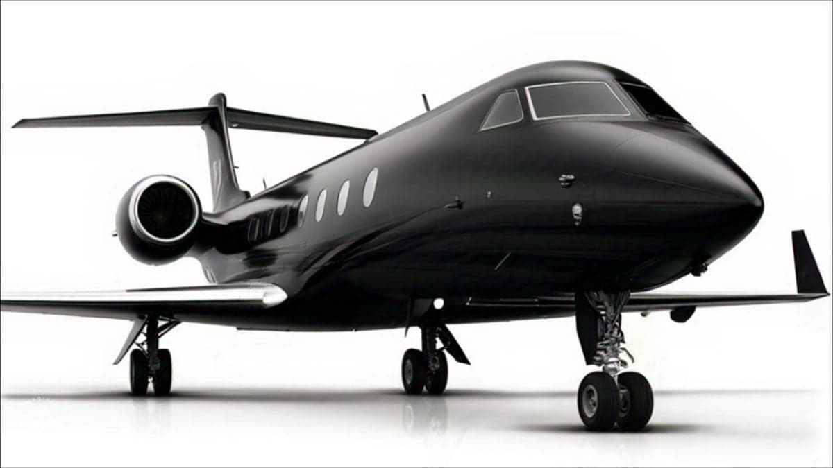 A black jet aircraft is shown in a studio setting.