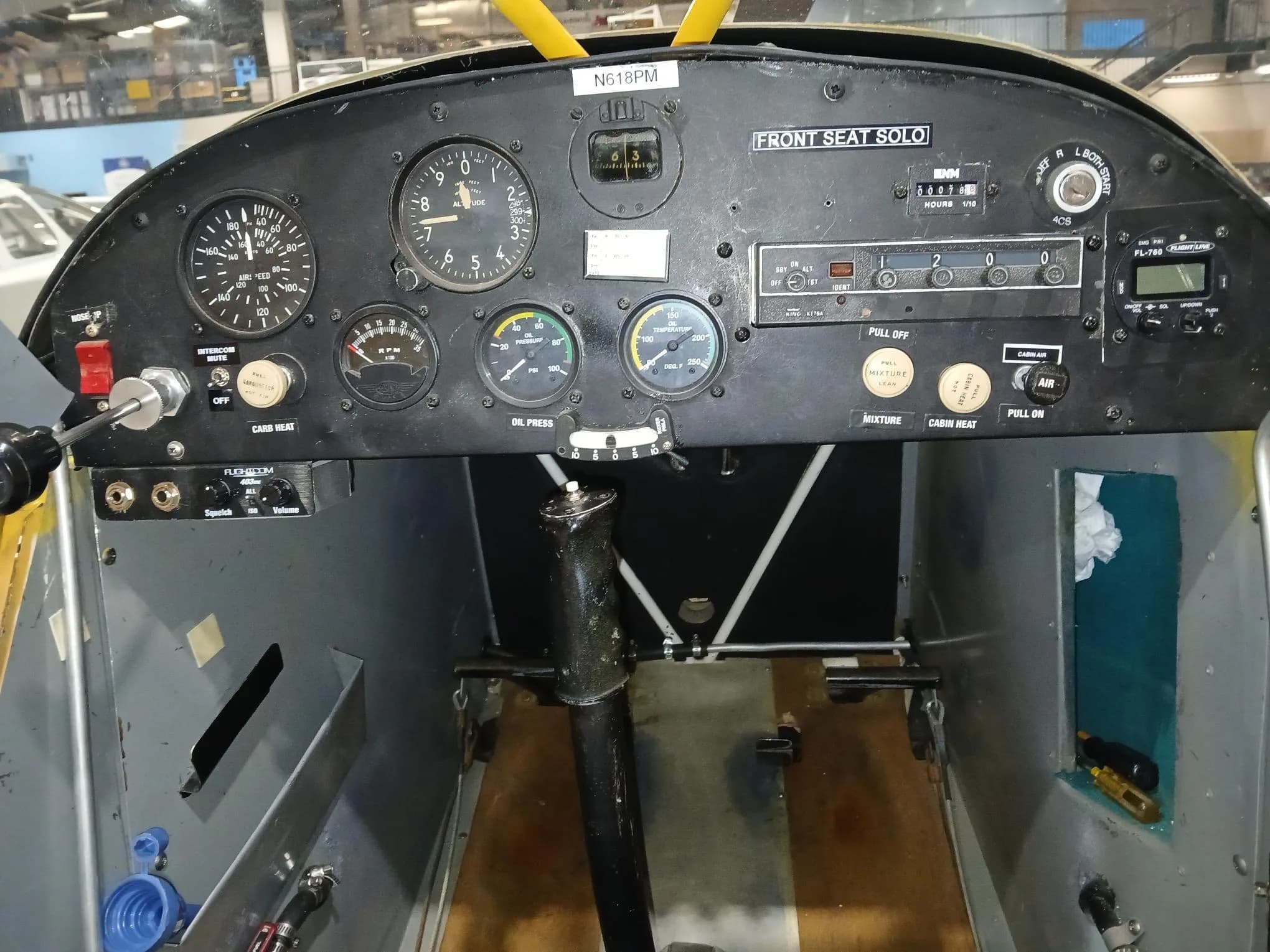 The instrument panel of the N618PM aircraft, showing gauges, radios, and controls.