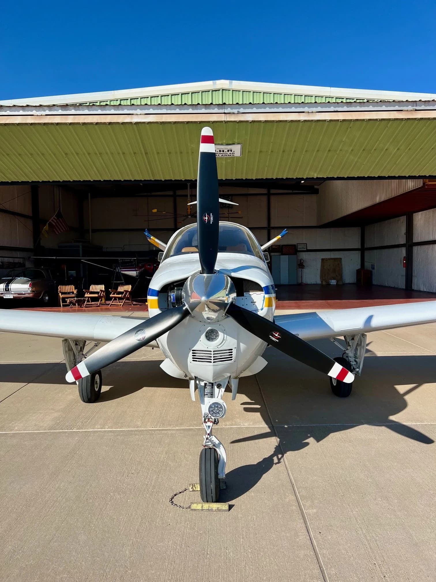 Front view of the aircraft with the propeller and landing gear visible.