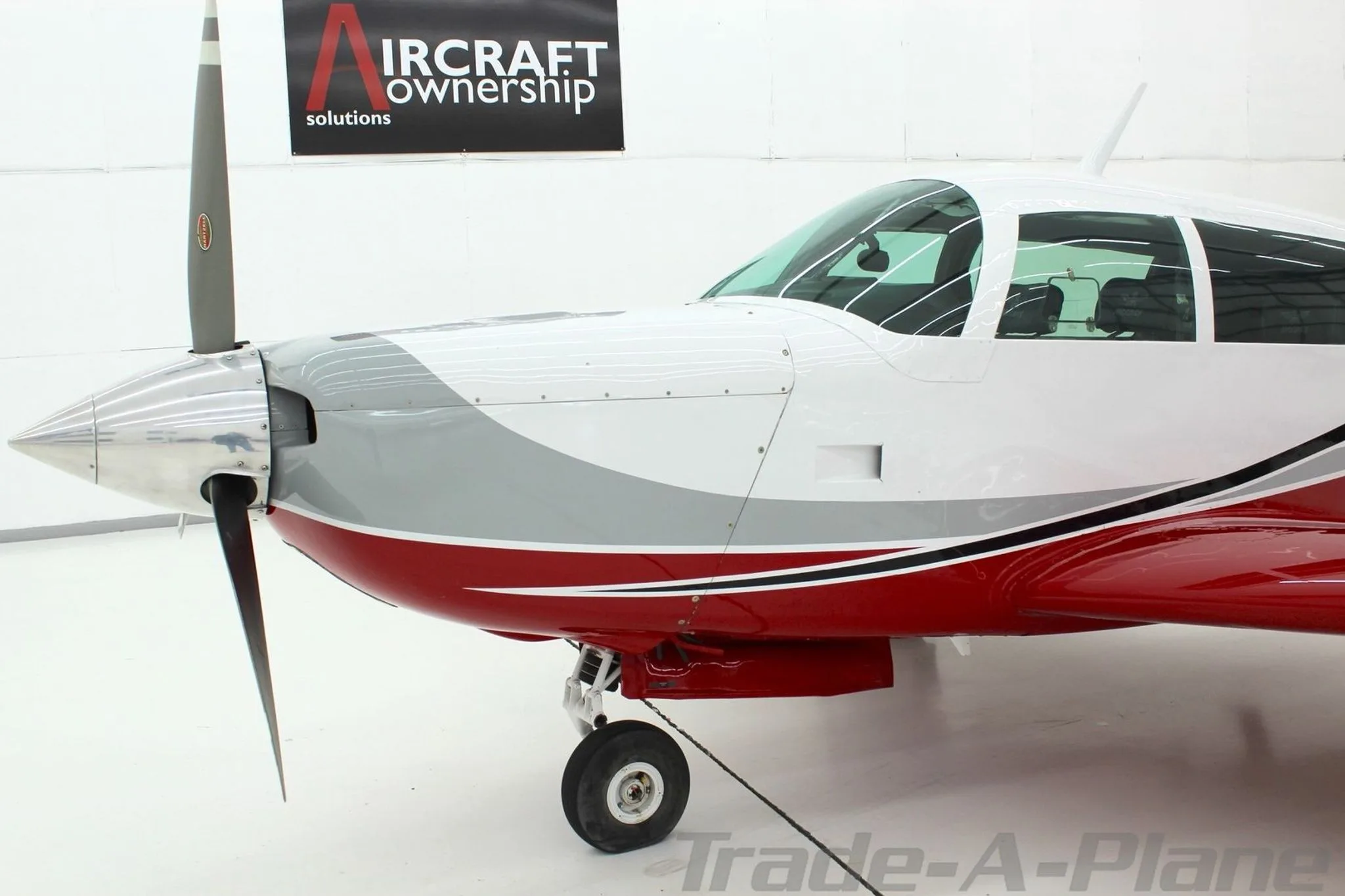A close-up of the front fuselage and propeller of the Mooney N1039B.