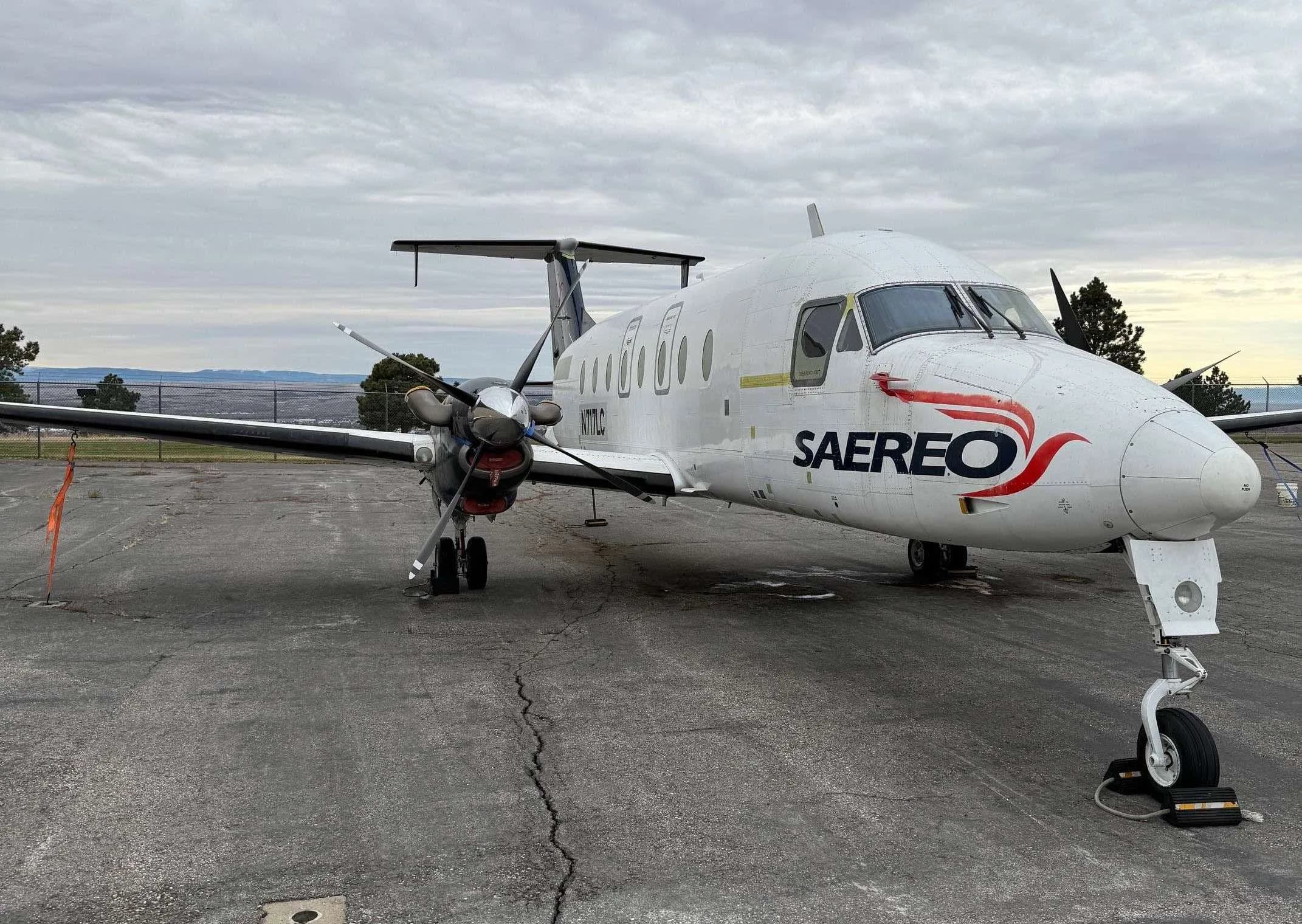 A Beechcraft 1900C with SAEREO livery is parked on the tarmac.