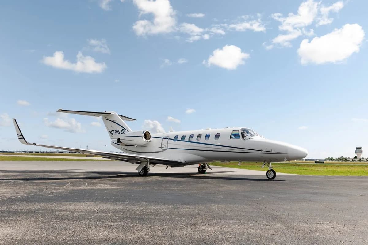 Front-side view of a white Cessna Citation private jet with registration N788JS parked on the tarmac.