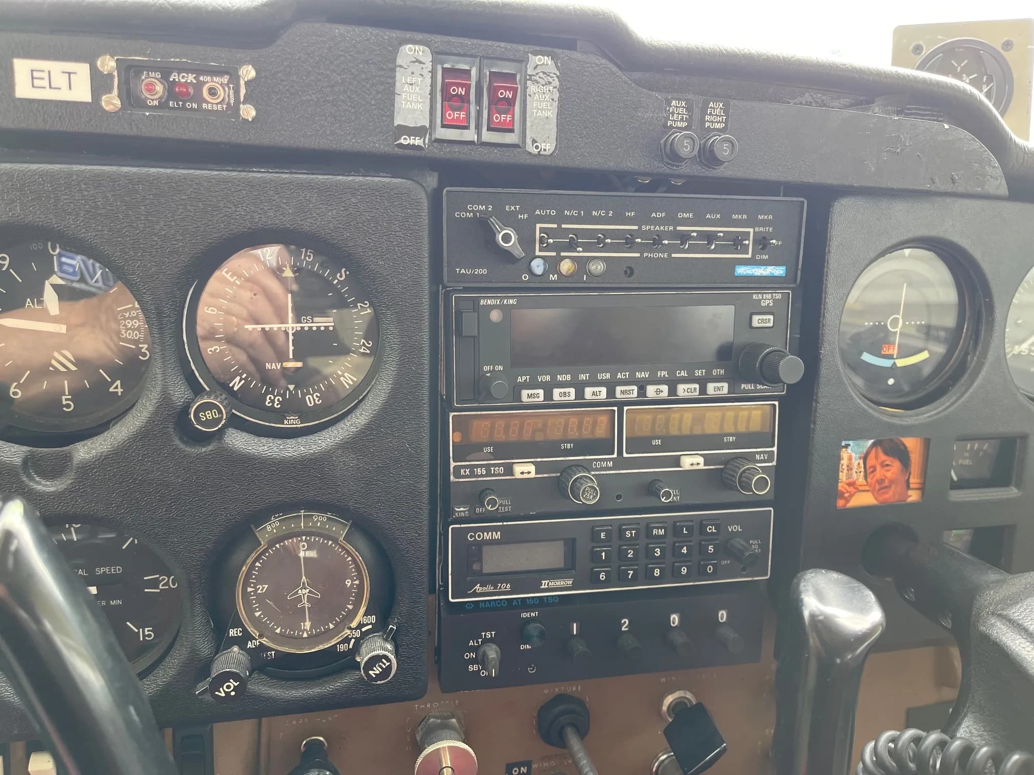 Aircraft cockpit instrument panel with avionics and gauges.