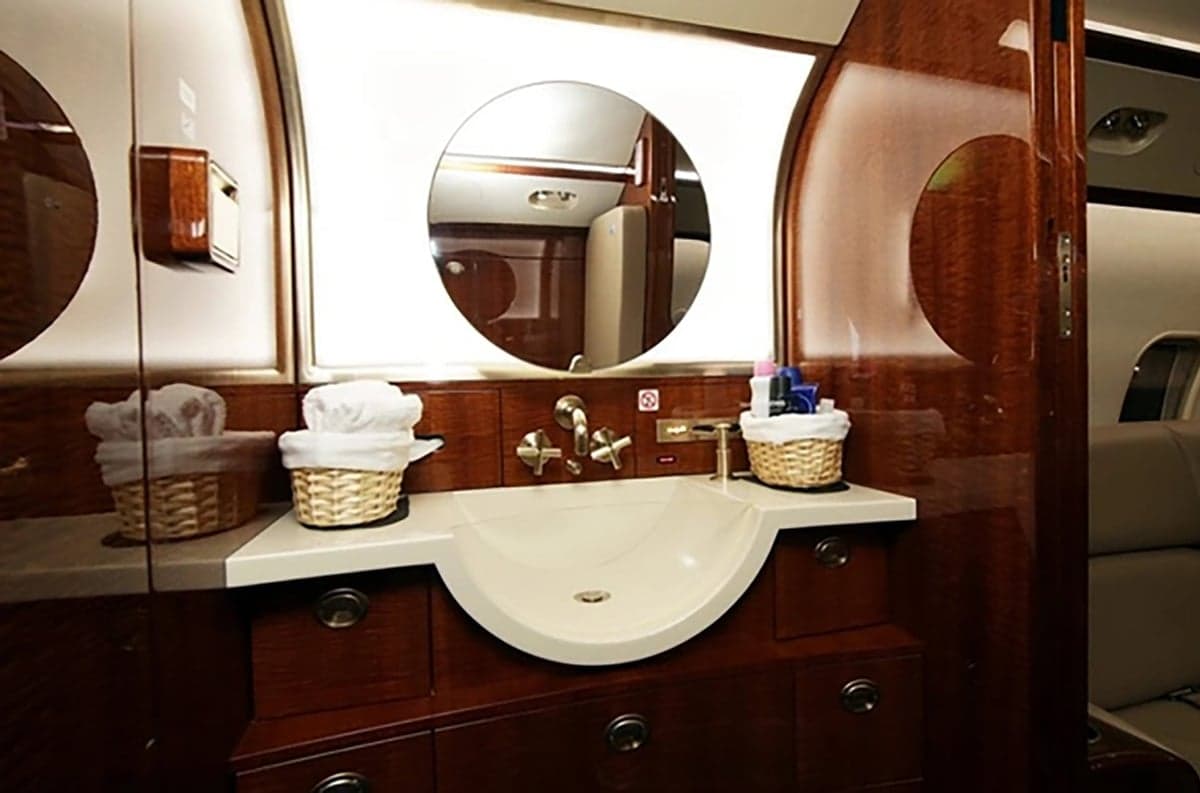 View of the aircraft lavatory with a sink and mirror.