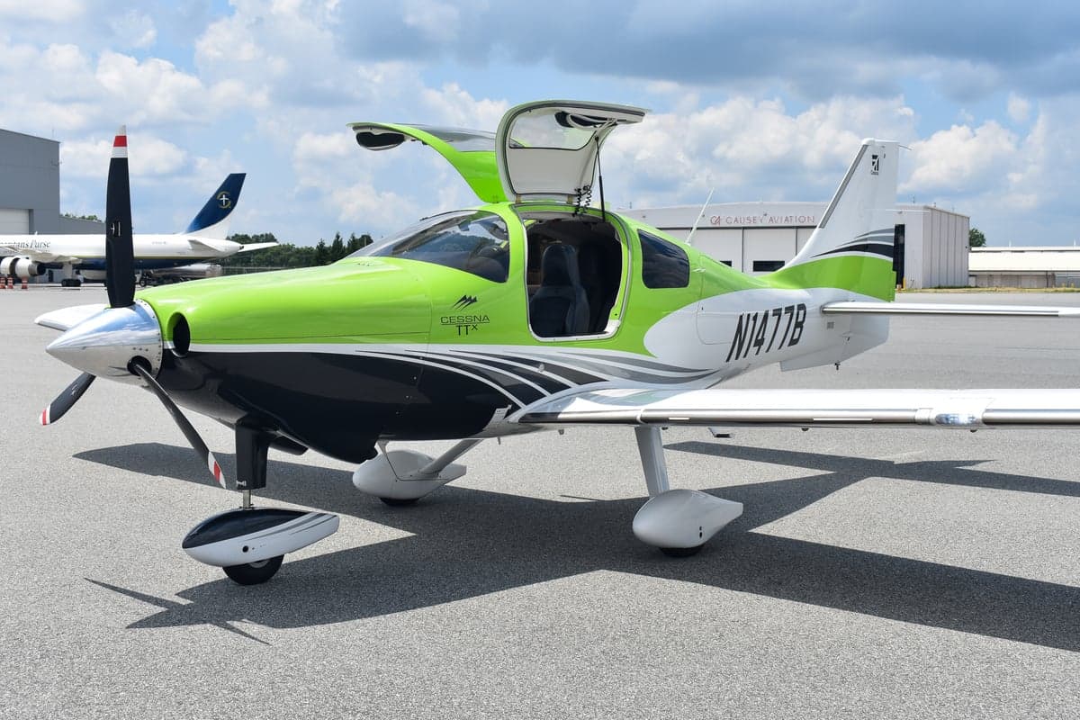 Side view of a green and black Cessna TTX with tail number N1477B.