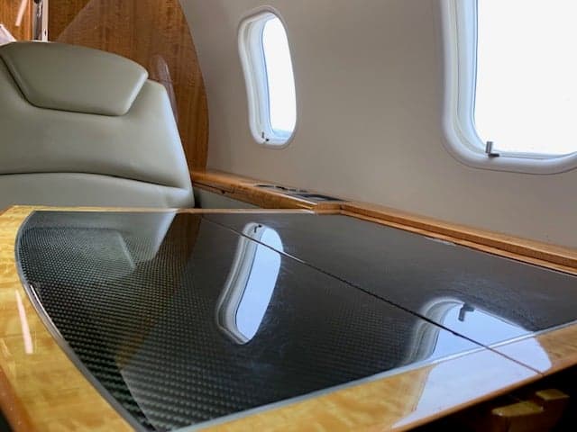 A close-up of the interior table and seat inside the aircraft.