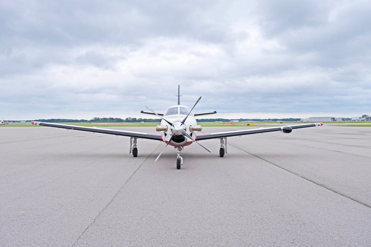 Front view of the TBM 850 aircraft N836EA on the tarmac.