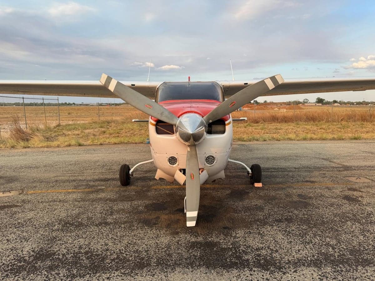 Front view of a Cessna 210 Centurion aircraft with its propeller.
