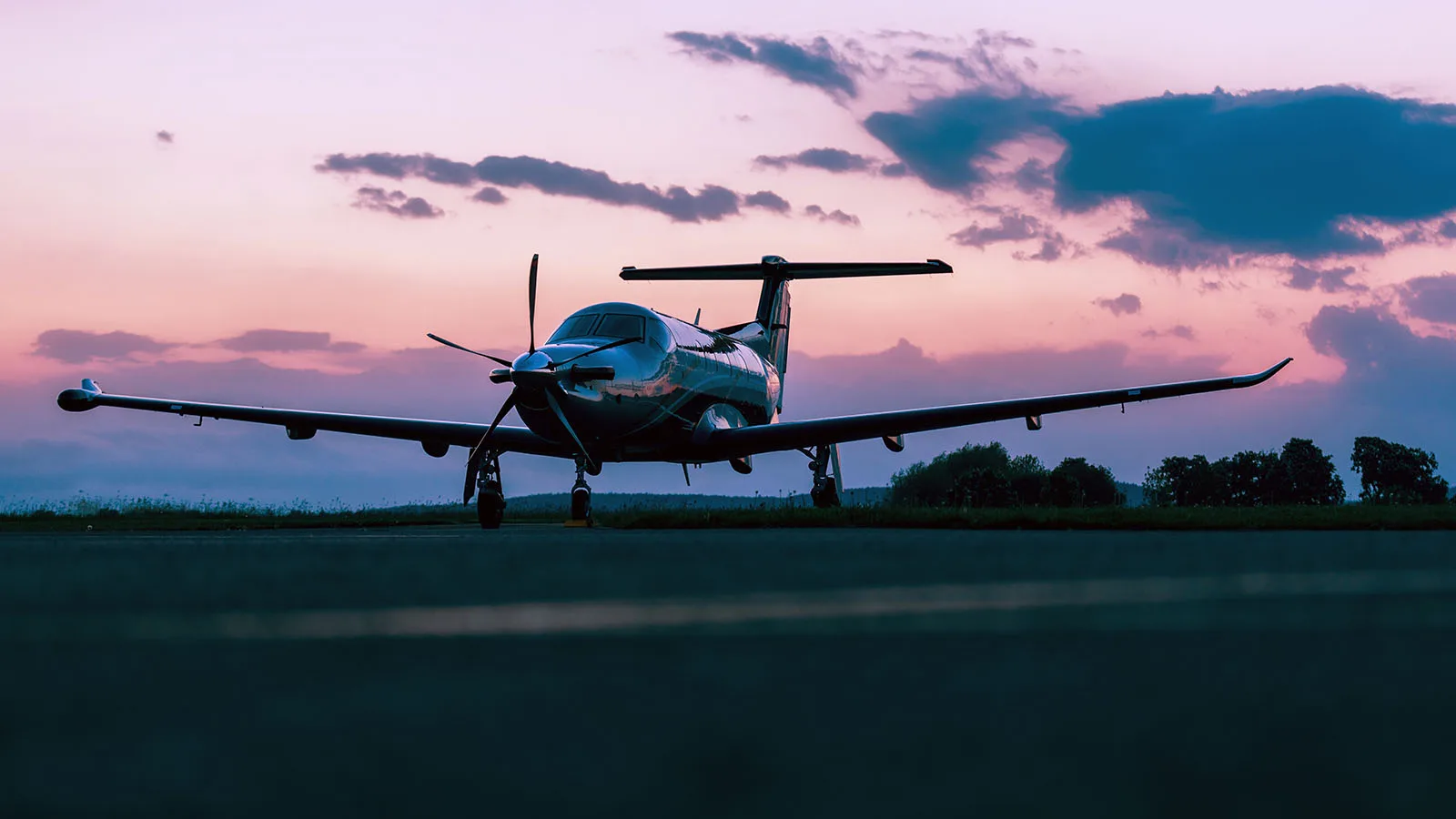 Turboprop aircraft on the ground at dusk.