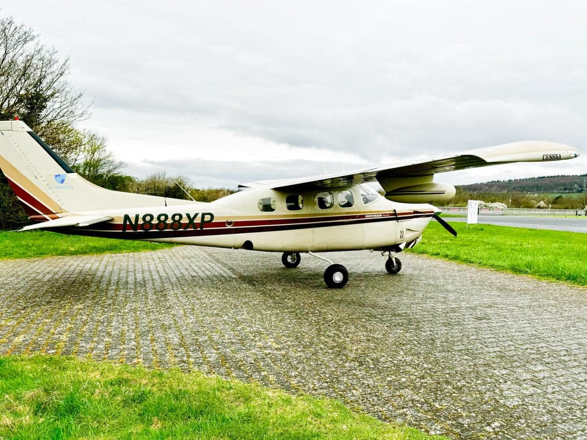 Cessna Centurion with a white and brown paint scheme on the tarmac.