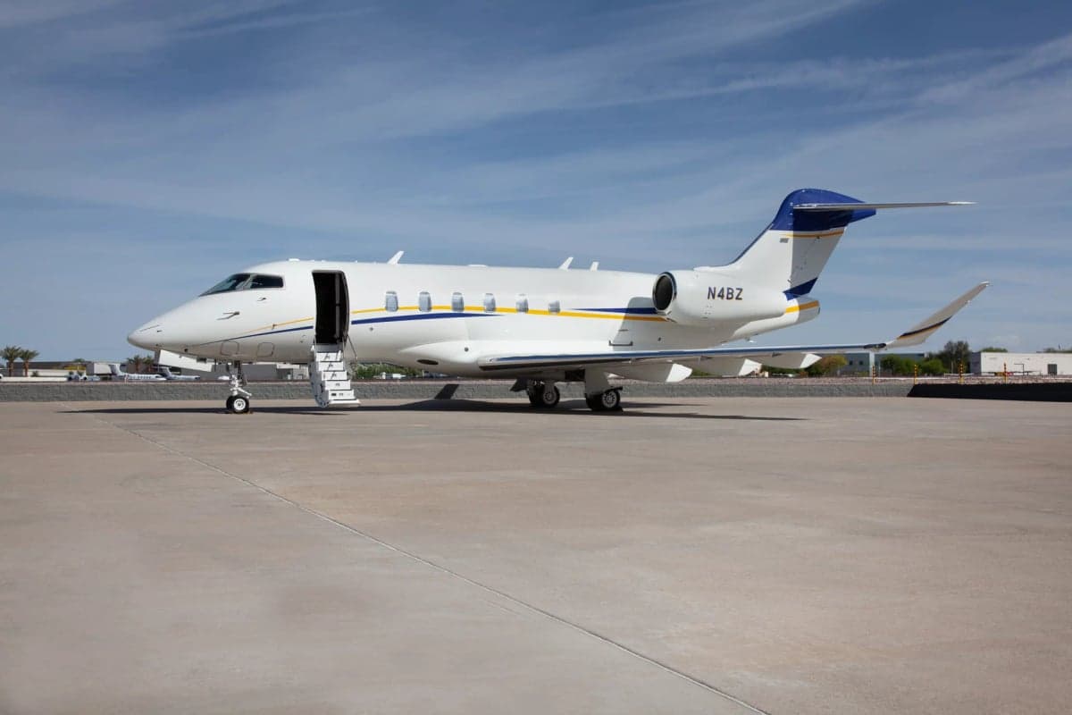 Side view of the N4BZ aircraft on the tarmac with the entry stairs extended.