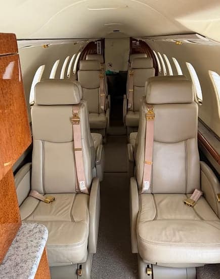 View of the Learjet's cabin with tan leather seats.