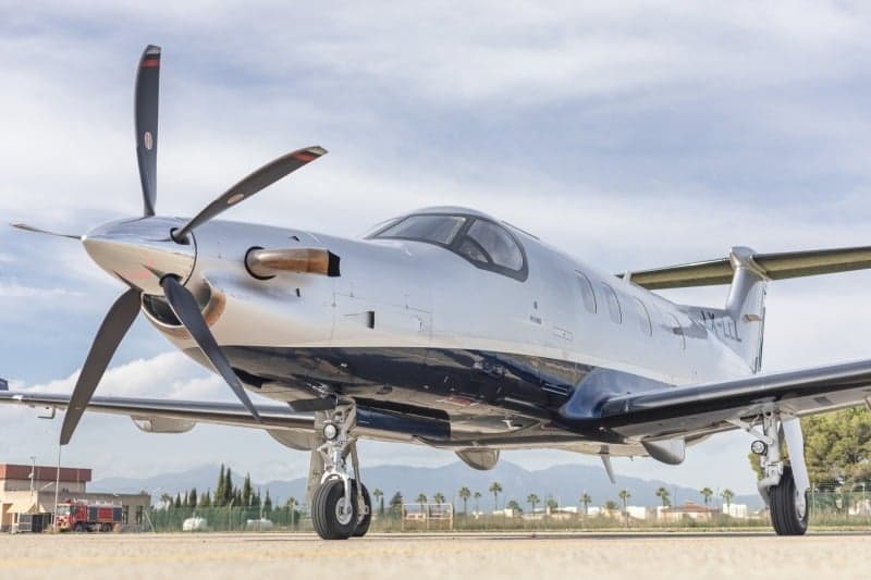 A Pilatus PC-12 aircraft with registration LX-LLL parked on the tarmac.