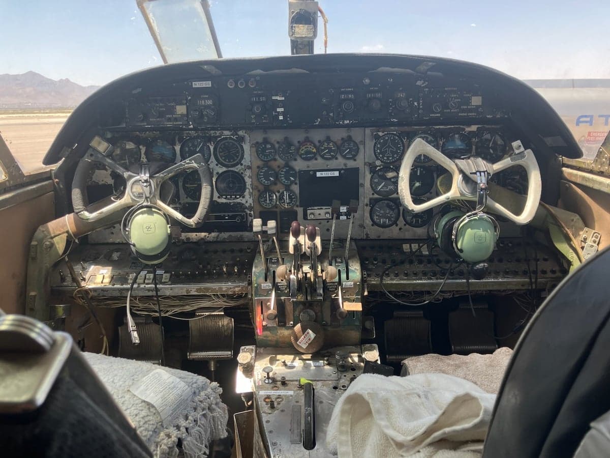 View of the cockpit of the Twin Bonanza, showing the instrument panel and yokes.