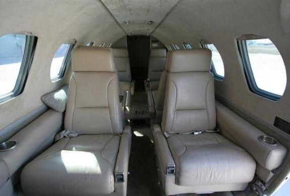 The interior of the aircraft features tan leather seats.